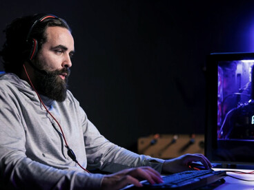 Man competing in an intense online video game tournament during a live stream