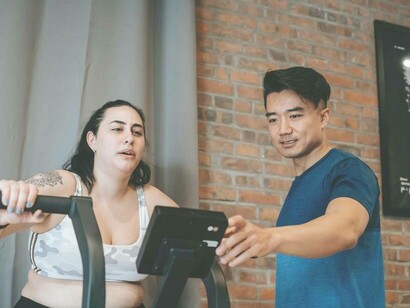 A woman exercising with a personal trainer