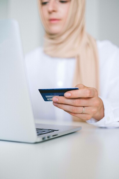 Woman using her credit card to make an e-commerce transaction
