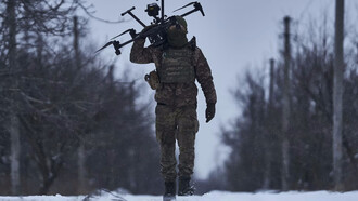 Soldado carga a sus espaldas un dron de guerra con Inteligencia Artificial