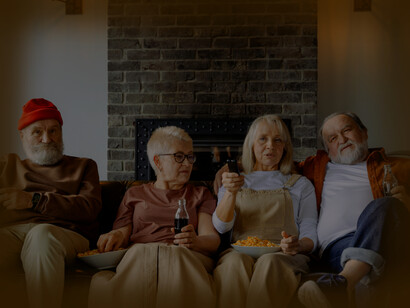 Two couples enjoying each others company, watching a movie together