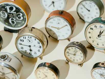 A photo of vintage alarm clocks, symbolizing the concept of time