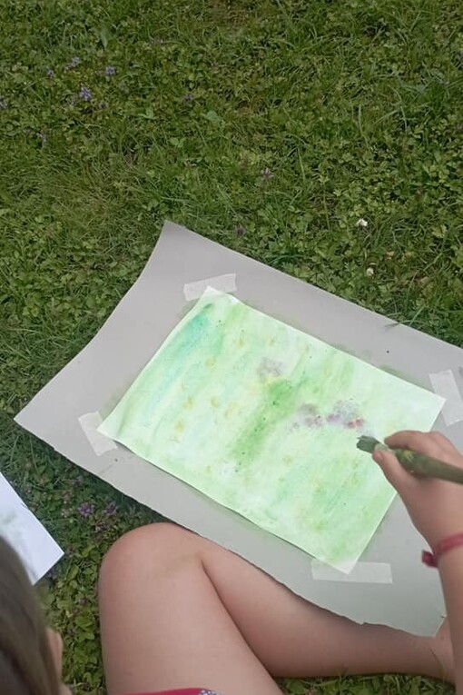 Allievo di Giampiero Monaca disegna su un prato  