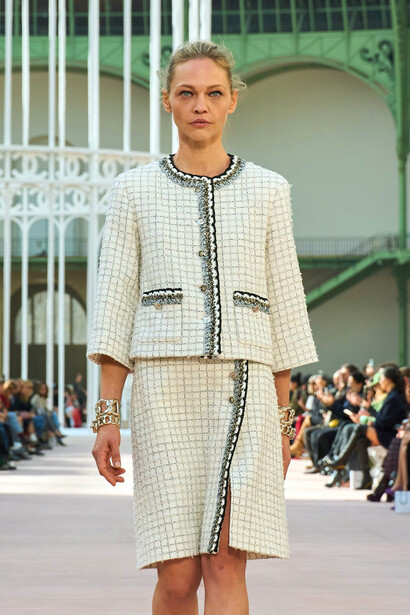 In a stunning display of elegance and innovation, a model glides down the Chanel runway, showcasing the collection's ethereal white outfits that embody the essence of summer freedom