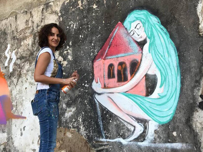 Marie-joe Ayoub painting a wall