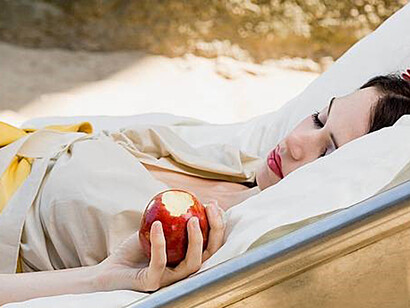 After partaking of the poisoned apple, Snow White finds herself in a deep slumber