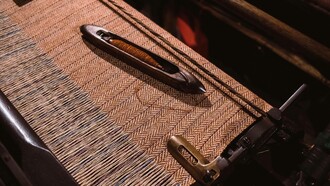 An industrial sewing machine using tweed as its fabric