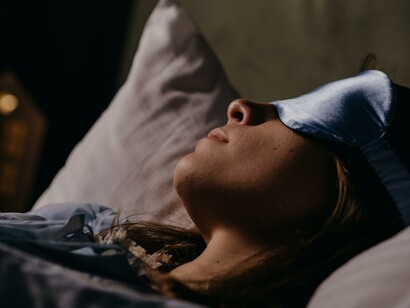 A person sleeping in a dark room 