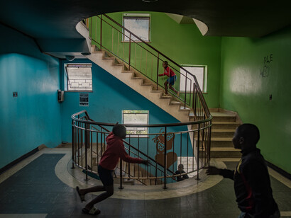Children playing on the stairs in an occupied building. Desperate and low-income families illegally occupy these houses, which presents difficulties for officials because illegal occupants start believing they have equal land rights