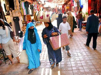 Women walking and talking in the streets of Morocco. Language shapes who we are as people, and as our languages develop and evolve, so do our identities