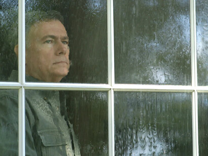 Un hombre mirando a través de la ventana