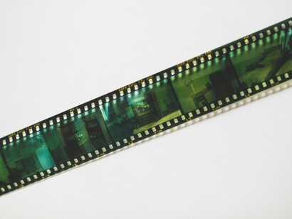 A lone film negative resting against a clean backdrop, reflecting the importance of preserving Argentina's audiovisual legacy before it fades away