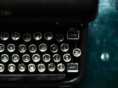 Typewriter's keys on a blue desk