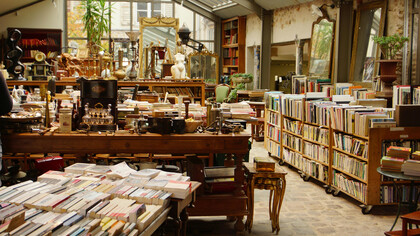 Cozy vintage bookshop overflowing with books, antiques, and nostalgic décor
