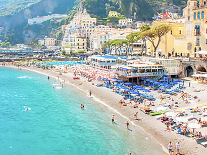 Visitors relaxing and swimming at Amalfi's scenic beach, Italy