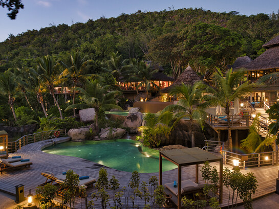 The pool at Constance Lemuria in Praslin, Seychelles, offers a serene space surrounded by lush tropical greenery