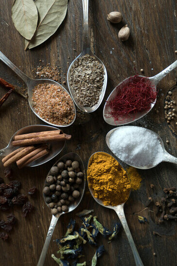 Spices and herbs displayed on spoons, evoking the rich heritage of Caucasian traditional medicine