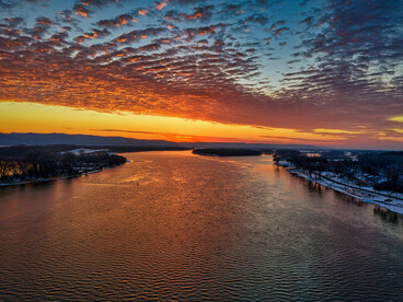The landscapes of Kellogg and the Mississippi river captured from above at sunset, reflecting the beauty of journeys both inner and outward