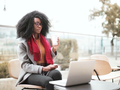 A student with coffee in hand is checking out her latest semester schedule for her bachelor of arts degree