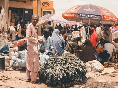 An African marketplace with traders and essential commodities, symbolising the economic life that happens outside formal financial institutions