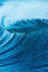 The roar of the tides: a powerful ocean wave curls and crashes, its deep blue waters shimmering under the light, reflecting both motion and depth, mirroring the ever-changing currents of thought and emotion