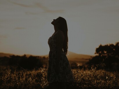 Alone in a field taking a deep breath while looking at the sky is a step towards embracing the self-love
