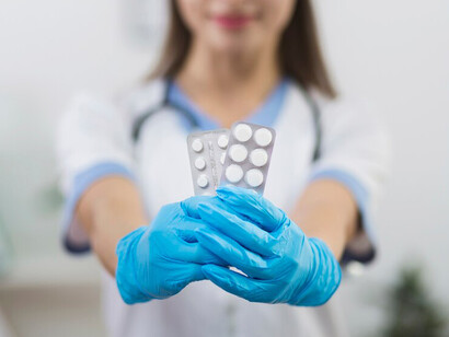 Female doctor holding oral medication pills, showcasing drug delivery systems and pharmaceutical solutions