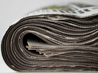 Newspapers on a white backdrop: an emblematic portrayal of press freedom and journalistic integrity