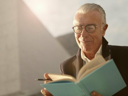 Idoso concentrado em sua leitura. Nós precisamos estimular muito a nossa imaginação, pois é de lá que vem a criatividade