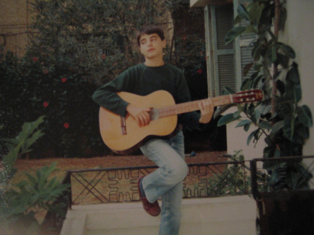 Young Yasser Mroué playing the guitar. From Rabih Mroué, Riding on a Cloud, 2013.