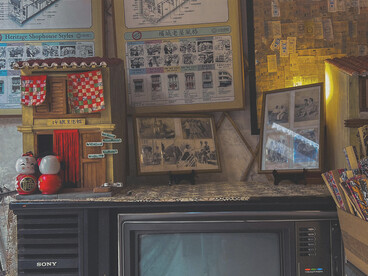 A vintage TV set and home décor bathed in warm light filtering through living room curtains, evoking nostalgia