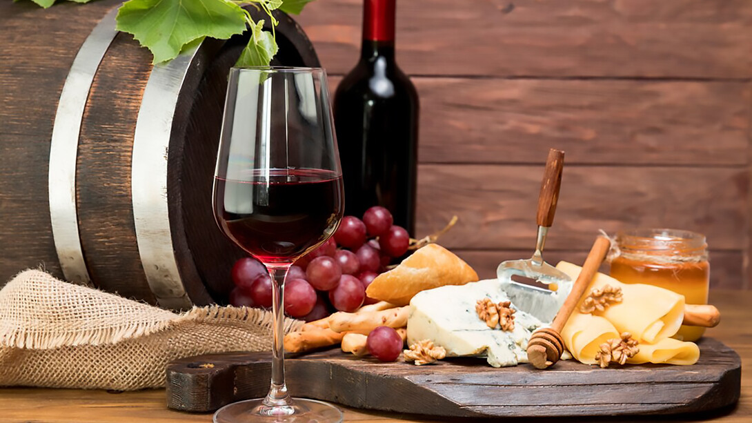 Rustic wooden barrel paired with wine, tapas, and a variety of cheeses
