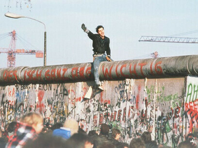 A young man celebrates the fall of the Berlin Wall in November 1989, Berlin, Germany
