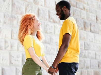 A happy interracial couple featuring an African American man and a white woman smiling together