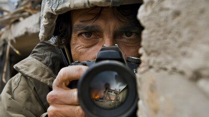 Through war photography and photojournalism, a photographer chronicles life in conflict zones, revealing the human cost of war and humanitarian struggles