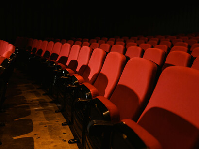 The AI script opens with a shot of empty seats in a silent movie theater