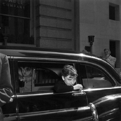 Audrey Hepburn, looking out from the window