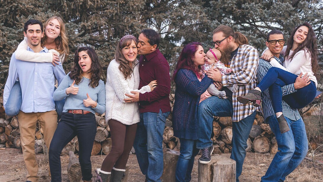 A family assuming different poses some with their partners and some are single