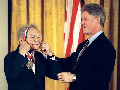 Previous US President Bill Clinton helps Paul Samuelson with the 1996 National Medal of Science award