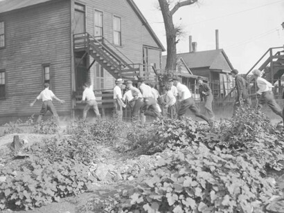 Chicago History: A victim is stoned and bludgeoned under the corner of a house during the Chicago Race Riot in 1919