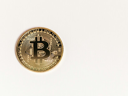 A crypto coin on a light surface exhibit how the world is progressively opening up to crypto assets