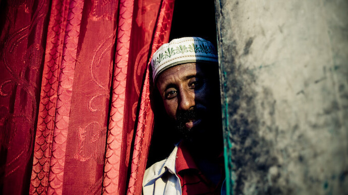 A Somali elder, his gaze veiled in shadow, symbolizes the resilience of Somaliland, a nation forged by its people's determination since civil war's end in 1991