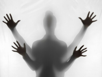 Dark, shadowy hands reaching out, capturing the essence of anxiety and the silent suffering of an individual