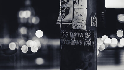 A pole covered in stickers serves as a stark reminder that big data is always watching you