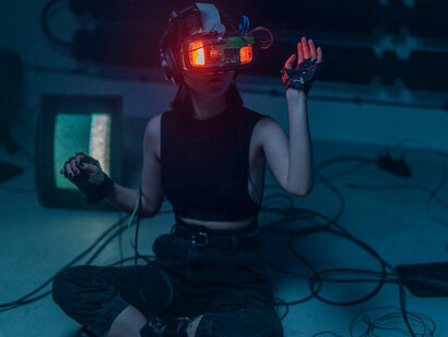 A woman seated on the floor, engrossed in the wonders of technology and artificial intelligence, was thoroughly enjoying the experience