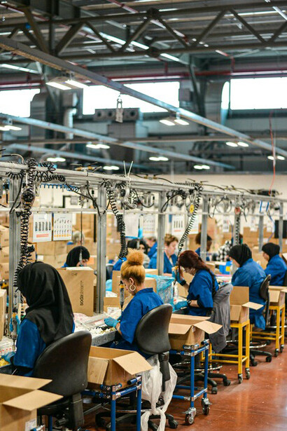 Women migrants engaged in factory work contribute significantly to the manufacturing sector, often balancing long hours and challenging conditions while playing a crucial role in sustaining industrial production