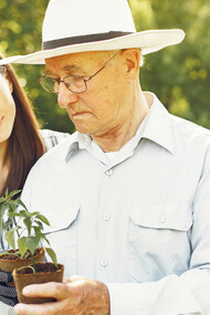 Granddaughter with grandpa, planting together