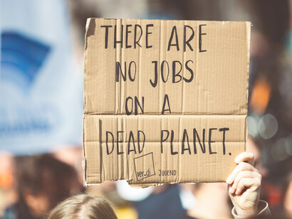 People protesting on the street against climate change and global warming, holding campaign banners