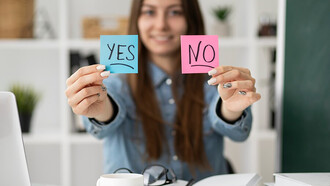 A blurry image of a woman holding Post-it notes — yes or no?