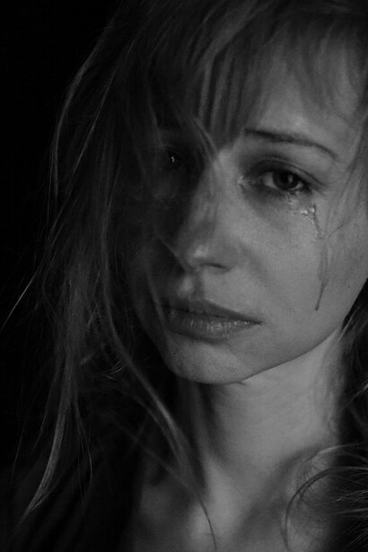 Woman with eyes open in tears